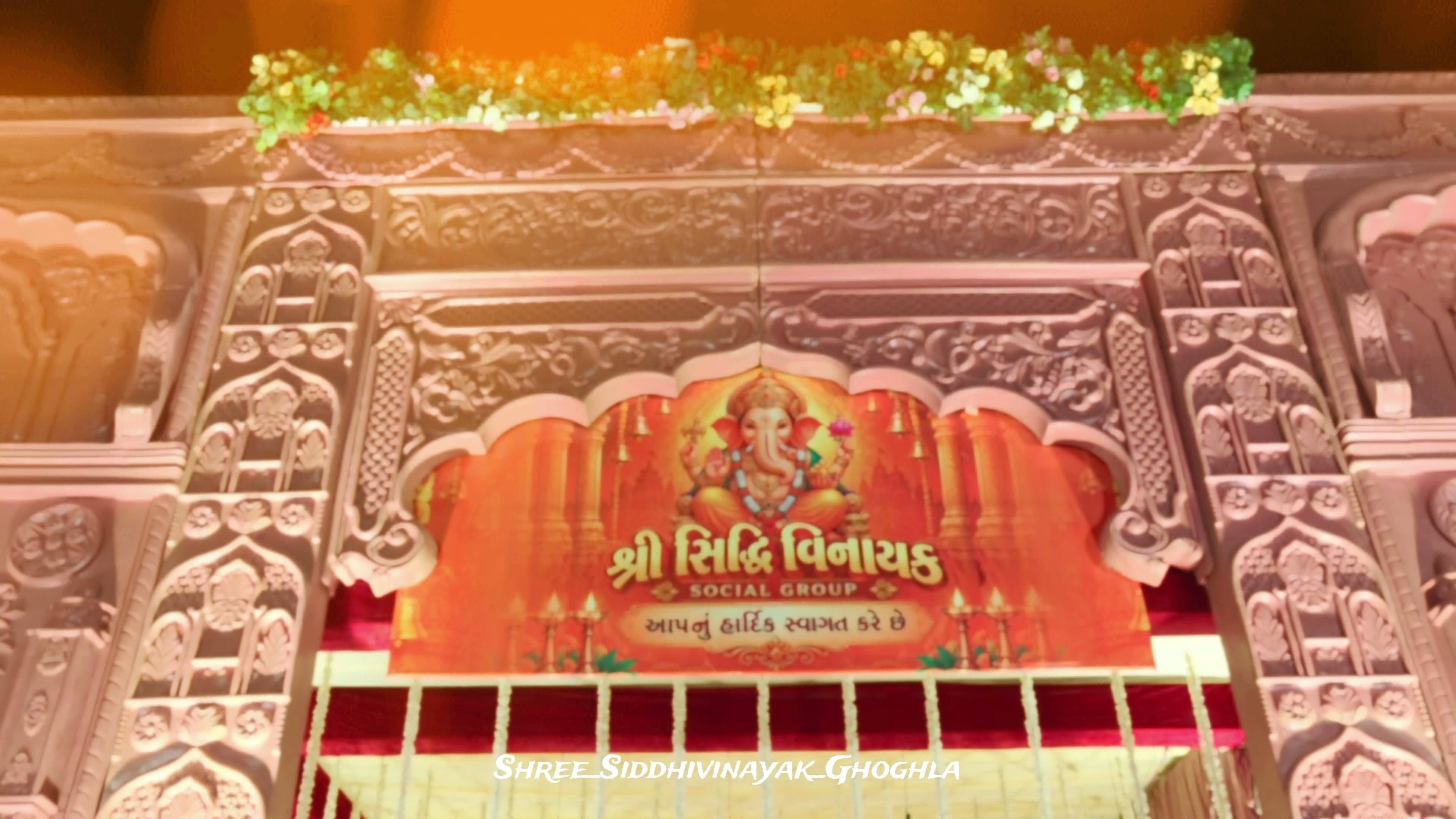 Carved floral toran gateway welcoming guests to the Shree Siddhivinayak Ganesh Utsav mandap